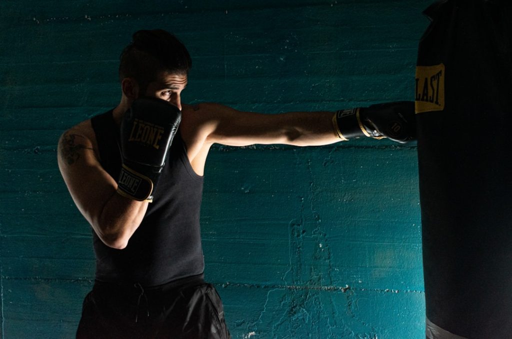 man-in-black-tank-top-and-black-shorts-wearing-black-boxing-gloves-de5ozmjb5ww